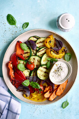 Grilled vegetables with yoghurt sauce. Top view with copy space. Top view with copy space.