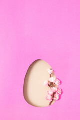 Paper cut Easter egg with cherry blossom branch. Copy space for greeting with Easter day. Minimalistic design