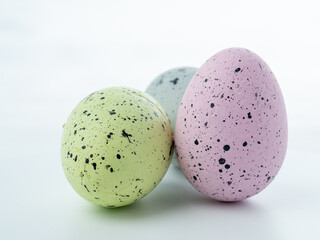 Close-up, colored styrofoam eggs on a white background.