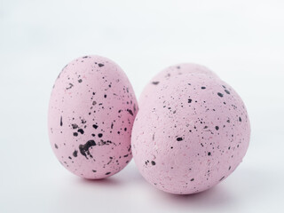 Close-up, colored styrofoam eggs on a white background.