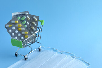 Tablets in a store cart and masks on a blue background.