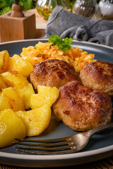 Meatballs  served with fired potatoes.