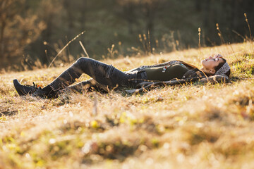 Woman Lying Down On The Meadow And Enjoying Sun