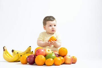 Fototapeta na wymiar Cute baby boy sitting with fruits and vegetables isolated on white background healthy food feed baby