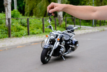 Fototapeta na wymiar Hands pass the keys to the motorbike.