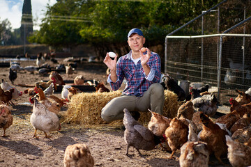 Fototapeta premium male worker in ecological chicken farm