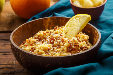 Couscous masfouf with dried fruits and nuts on a blue napkin.
