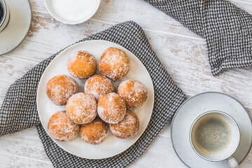 Fried curd balls with sugar on white wooden background, top view. Concept of coffee break. Copy space.