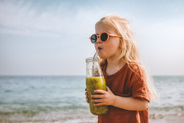 Kid girl drinking smoothie on beach healthy eating lifestyle vegan food breakfast child with glass...