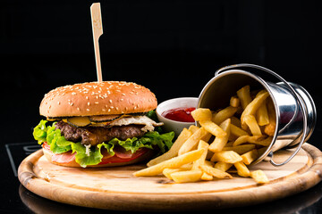 Set of burgers with french fries and ketchup sauce. Big hamburgers and french fries. Fast food set...