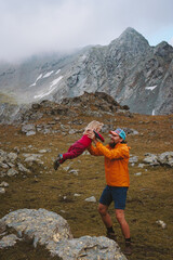 Father playing with daughter outdoor in mountains family travel vacations hiking outdoor adventure healthy lifestyle trip sustainable tourism