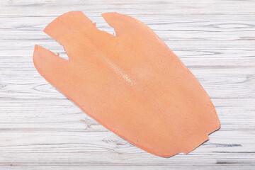 natural colored grey rays leather on the wooden table	