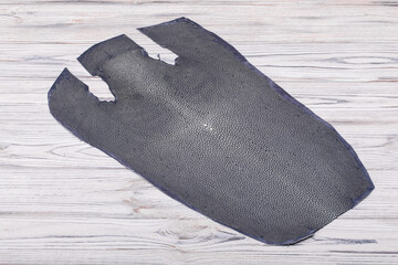 natural colored grey rays leather on the wooden table