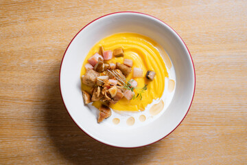 Pumpkin puree with ham and croutons. Menu design concept for a restaurant.