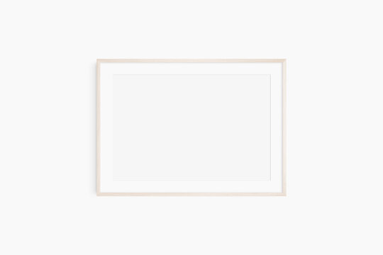 Horizontal frame mockup 7:5, 70x50, A4, A3, A2, A1 landscape. Single light wood frame mockup. Clean, modern, minimalist, bright. Passepartout/mat opening in 3:2 aspect ratio.