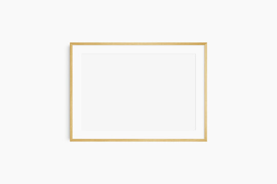 Horizontal frame mockup 7:5, 70x50, A4, A3, A2, A1 landscape. Single oak wood frame mockup. Clean, modern, minimalist, bright. Passepartout/mat opening in 3:2 aspect ratio.