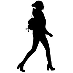 Black silhouette of slender woman in trousers, boots and backpack