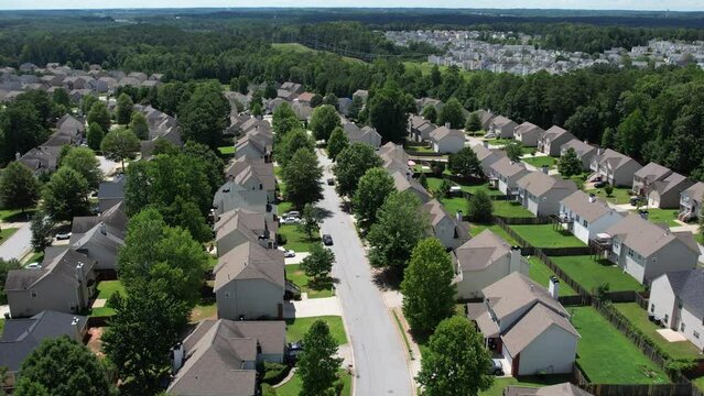 Flying over an American lush green suburban neighborhood.