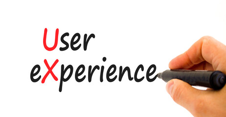 UX user experience symbol. Concept words UX user experience on white paper. Businessman hand with marker. Beautiful white background. Copy space. Business and UX user experience concept.