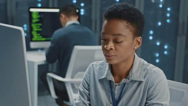 Smart female IT administrator office manager using computer performing financial startup analysis cloud computing at professiona data center.