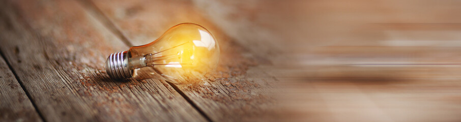 Light bulb on wooden surface