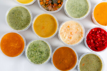 different kinds of soups on white background