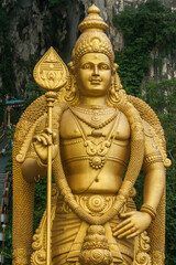 Close up of Murugan Statue (Tugu Dewa Murugga) in Batu Caves, Selangor, Kuala Lumpur. Tallest statue of a Hindu deity in Malaysia made with 300 liters of Gold Paint and 350 tons steel bar.