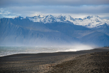 View during auto trip in Iceland. Spectacular Icelandic landscape with  scenic nature: mountains, ocean coast, fjords, fields, clouds, glaciers, waterfalls..