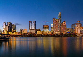 Fototapeta premium Panorama of downtown Austin Texas across Lady Bird Lake at sunset golden hour