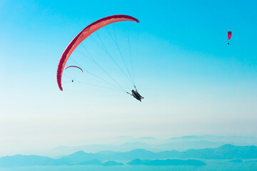 Paraglider flying on Oludeniz beach in Fethiye, Mugla, Travel destination. Summer and holiday concept.