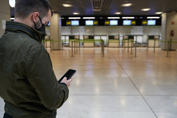 boy looks at his boarding pass on the mobile