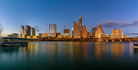Panorama of downtown Austin Texas across Lady Bird Lake at sunset golden hour
