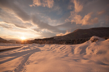 Majestic sunset in the winter mountains landscape. Dramatic sky. Azerbaijan nature.