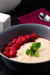 oatmeal with fresh raspberries is a healthy breakfast, oatmeal porridge in ceramic bowl with fresh ripe berries