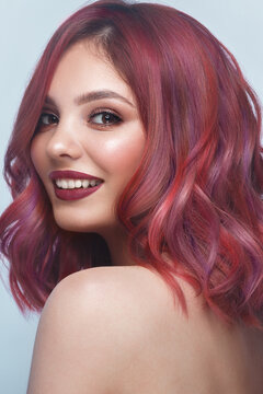 Beautiful girl with multi-colored hair and classic make-up and hairstyle. Beauty face.