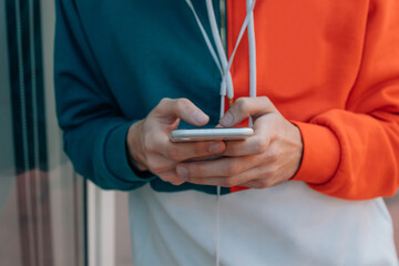 hands of young man with mobile phone