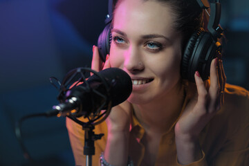 Young woman working at the radio station - obrazy, fototapety, plakaty