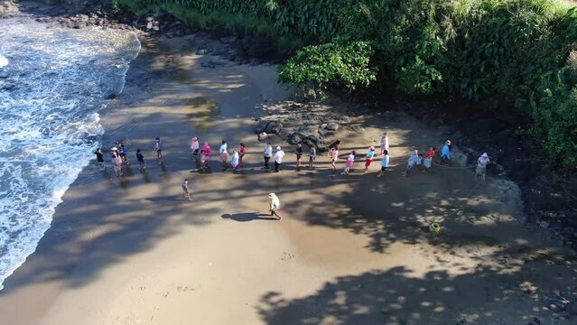 Artisanal collective fishing in Playa Hermosa aerial drone.. Traditional or subsistence fishing consists of various small-scale, low-technology, low-capital, fishing practices undertaken by individual