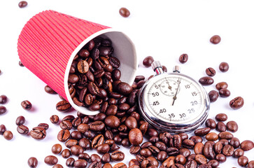 Roasted coffee beans fall out of the red cup and stopwatch, it's time to drink coffee