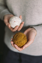 Woman with balls of yarn in her hands. Concept for handmade and hygge slow life.