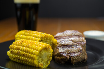 Delicious filet mignon close-up with roasted corn