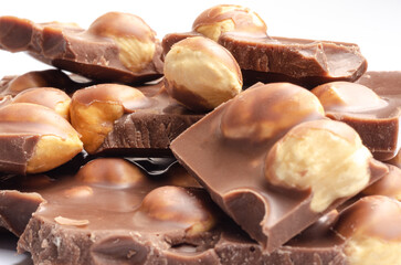 Closeup of whole hazelnuts in milk chocolate