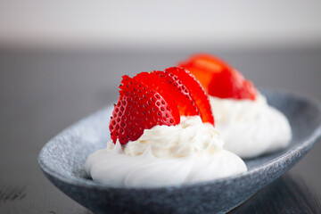 sweet mini cake Pavlova with strawberries whipped cream and meringue