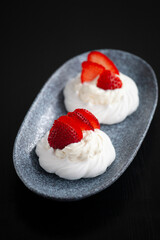 sweet mini cake Pavlova with strawberries whipped cream and meringue