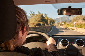 unrecognizable woman driving a car