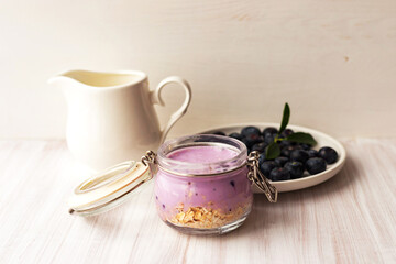 Oatmeal flakes granola or muesli with yogurt smoothie, fresh blueberry and ceramic jug milk