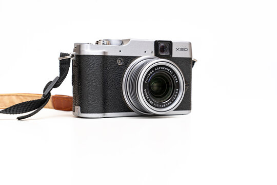 Fuji camera in retro style with a brown leather strap on a white background. 