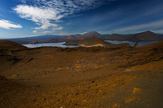 Desertic island landscape in Bartolome with cone shaped mountains under a blue sky