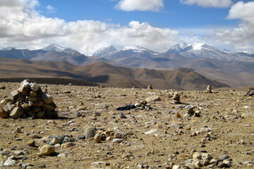 stones in the desert and view of the mountain peaks of Tibet