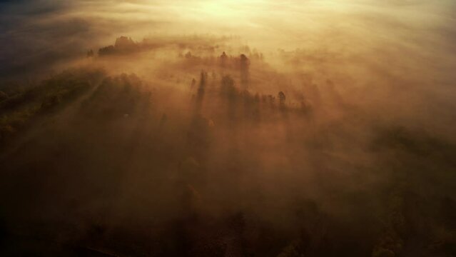 Sunrise over epic misty landscape, morning over the hills in the village aerial slow motion drone footage